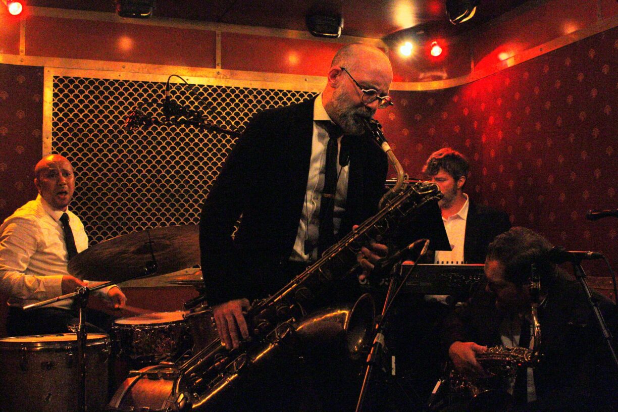 Saxophonist Ryan Anselmi performing live on stage with his band at Pete's Candy Store, NYC
