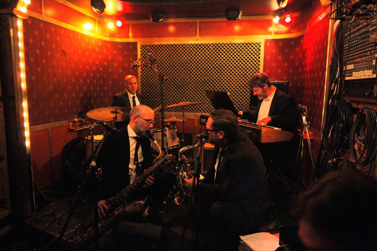 Close-up of saxophonist Ryan Anselmi performing live on tenor saxophone at Pete's Candy Store, NYC